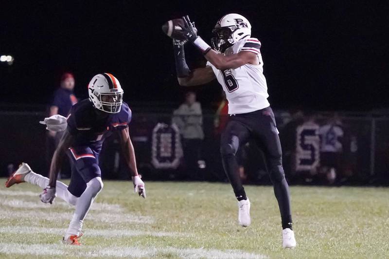 Plainfield North's Amiel Clark (6) catches a pass against Oswego’s Jeremiah Cain (1) during a football game at Oswego High School on Friday, Sept. 27, 2024.