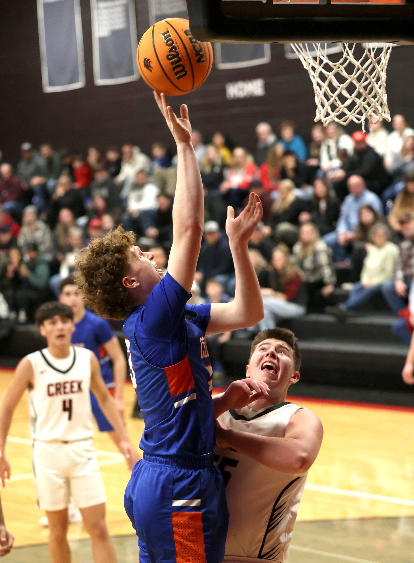 Genoa-Kingston's Jack Peterson shoots over Indian Creek's Payton Hueber during their game Friday, Jan. 3, 2025, at Indian Creek High School in Shabbona.