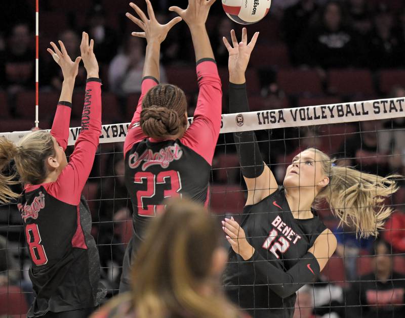 Benet’s Lynney Tarnow taps the ball against Marist’s Taylor Berg and Cassidy Cage in the Class 4A final match at the IHSA girls volleyball state tournament at Illinois State University on Saturday, Nov. 15, 2025