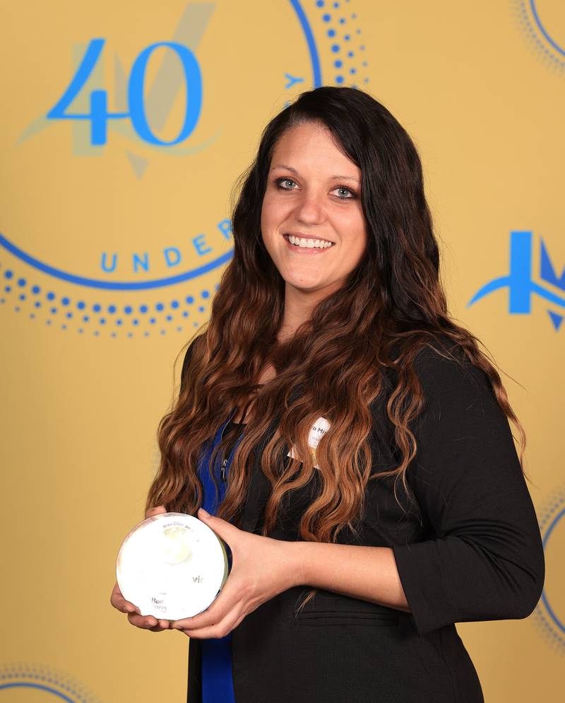 Tanya Miscevic poses with her 40 Under Forty award during the Illinois Valley Chamber of Commerce Champions of Change Awards Night on Thursday, April 10, 2025 at the Westclox Event Center in Peru.