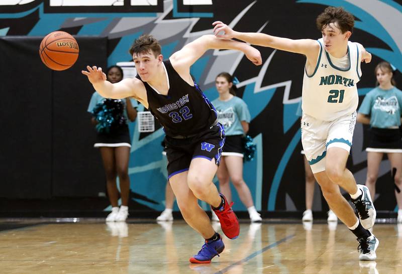 Woodstock's Keaton Perkins outraces Woodstock North's Cade Blaksley to the ball during a Kishwaukee River Conference boys basketball game on Friday, Jan. 5. 2024, at Woodstock North High School.