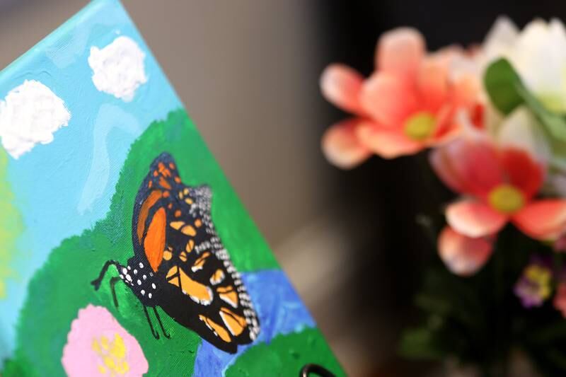 Art work is displayed during Monarchs and Music at Crystal Lake Main Beach Sunday.