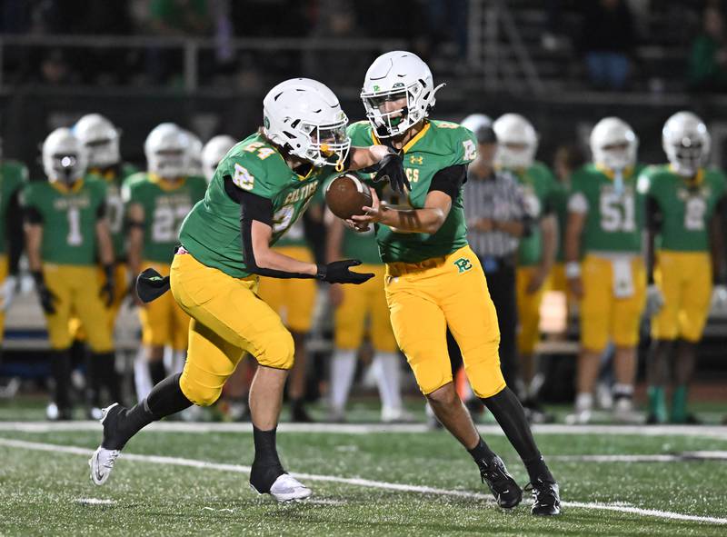 Providence Catholic's Tyler Payne (8) hands the ball off to Broden Mackert (24) during the non-conference game against St. Francis on Friday, SEP. 26, 2025, at New Lenox.
