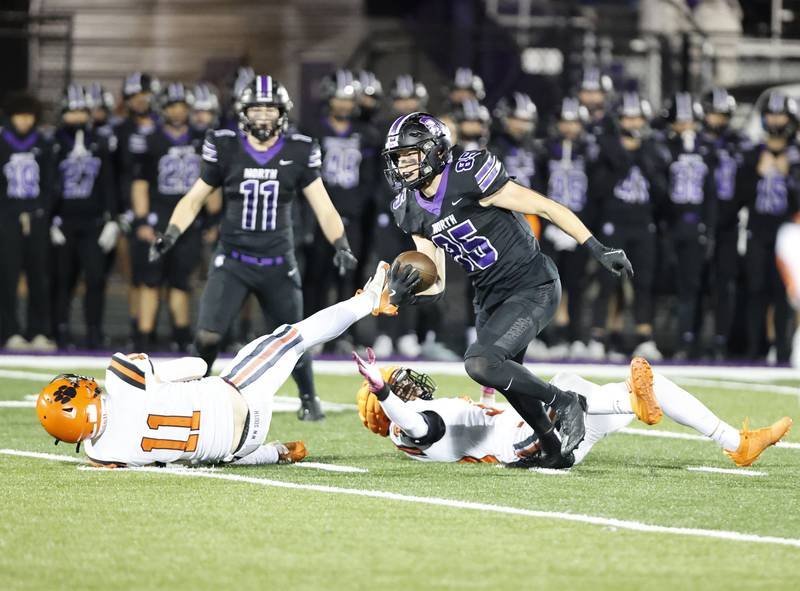 Downers Grove North's Will Vala (85) breaks some tackles on the way to a touchdown during the 7A first-round playoff game between Wheaton Warrenville South and Downers Grove North high schools on Friday, Nov. 1, 2024 in Downers Grove.