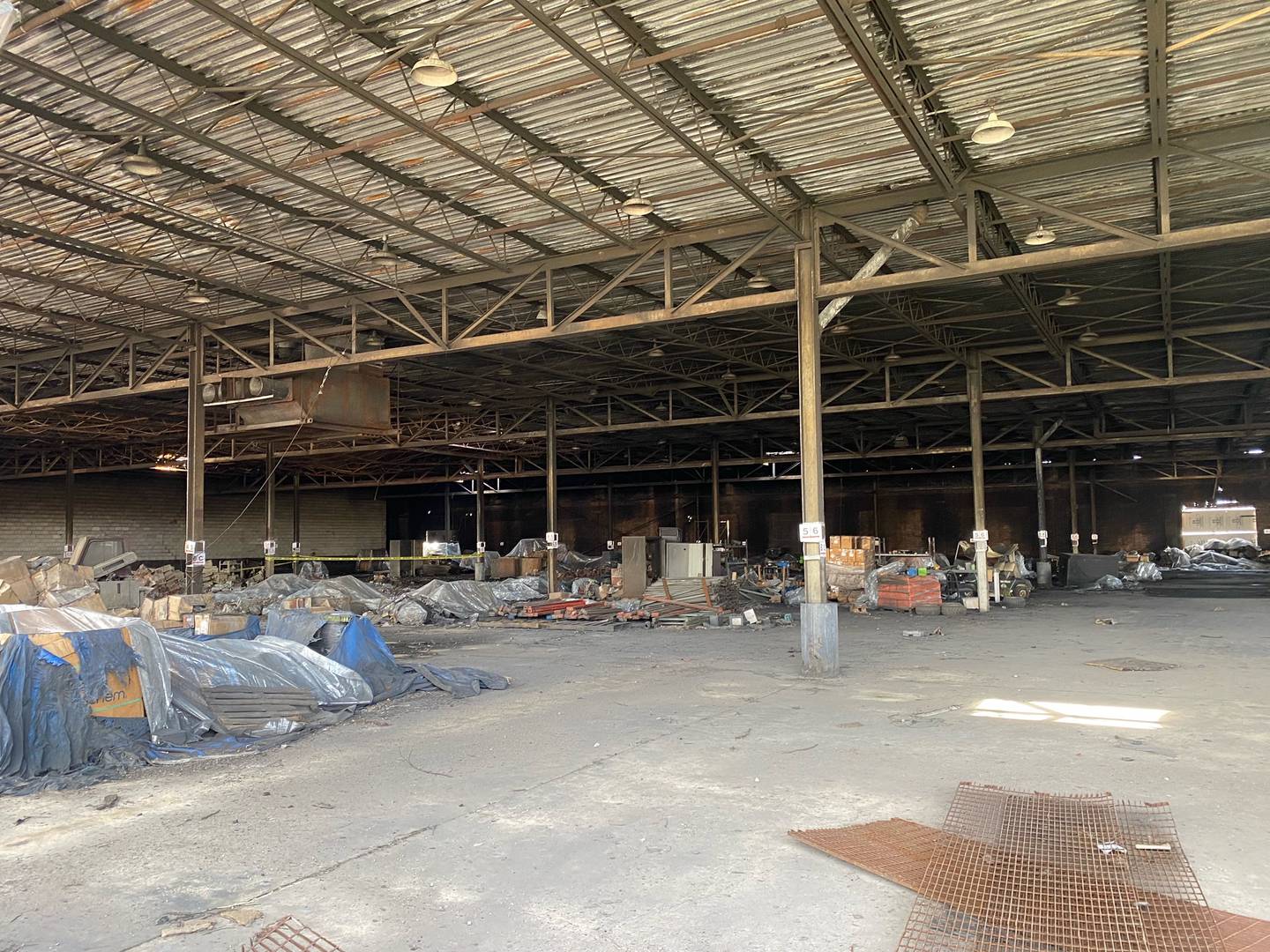 The inside of the Benton St. warehouse shows materials covered and secured to keep them dry before cleanup.