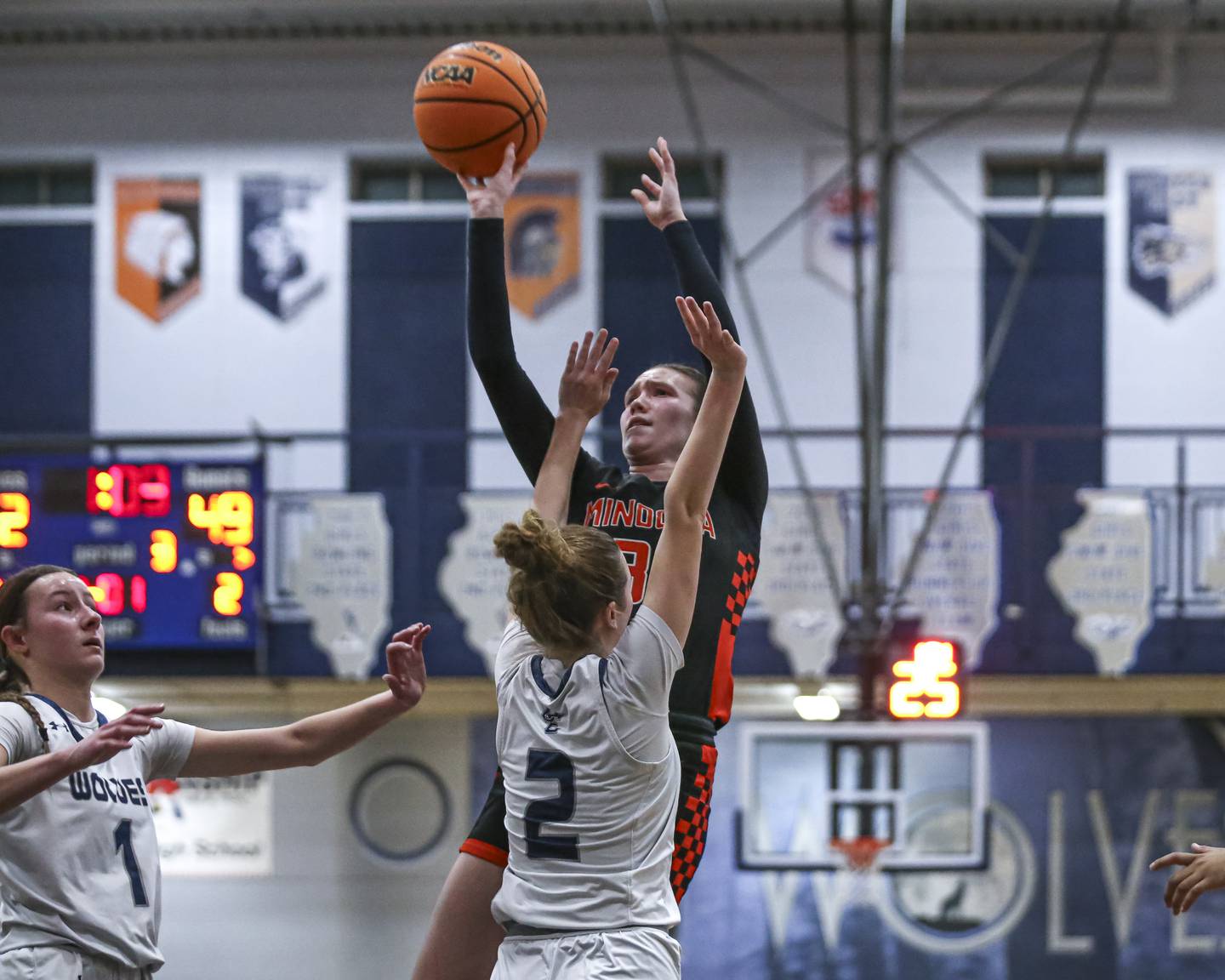 Minooka's Madelyn Kiper (31) puts up a shot over Oswego East's Annabelle Williams (2) during their basketball game between Minooka at Oswego East Friday, Jan 16, 2026 in Oswego.