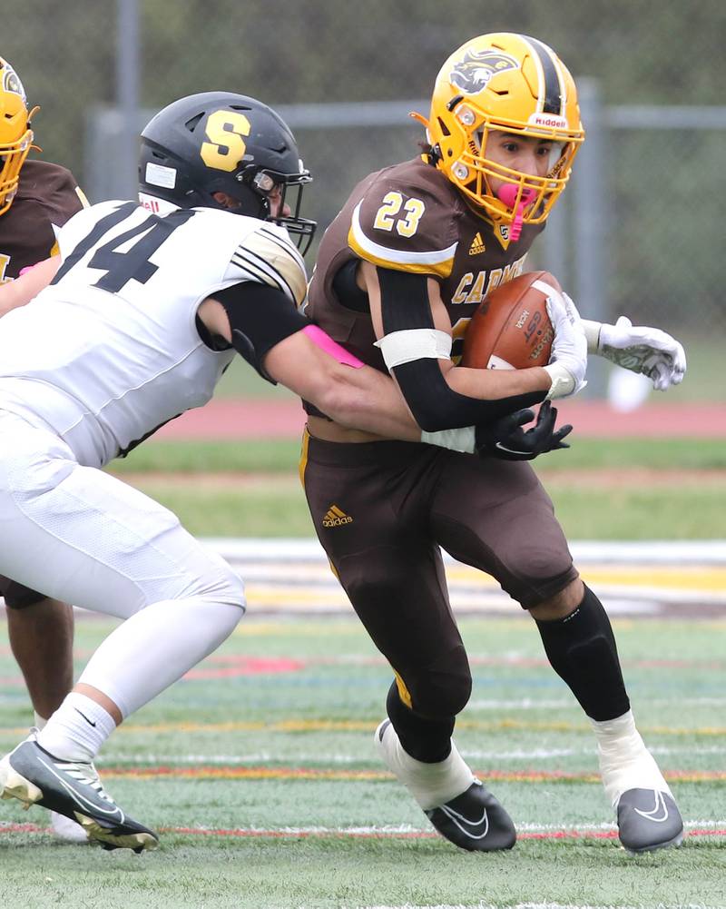 Carmel's Donovan Dey tries to break the tackle of Sycamore's Kiefer Tarnoki during their Class 5A second round playoff game Saturday, Nov. 5, 2022, at Carmel Catholic High School in Mundelein.