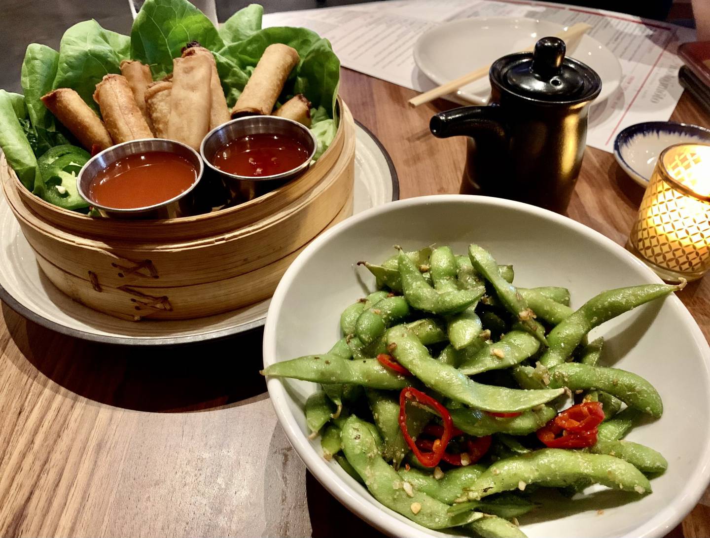 Lumpia (Filipino egg rolls), left, and spicy edamame, right, are appetizers available at Moto Imōto in downtown St. Charles.