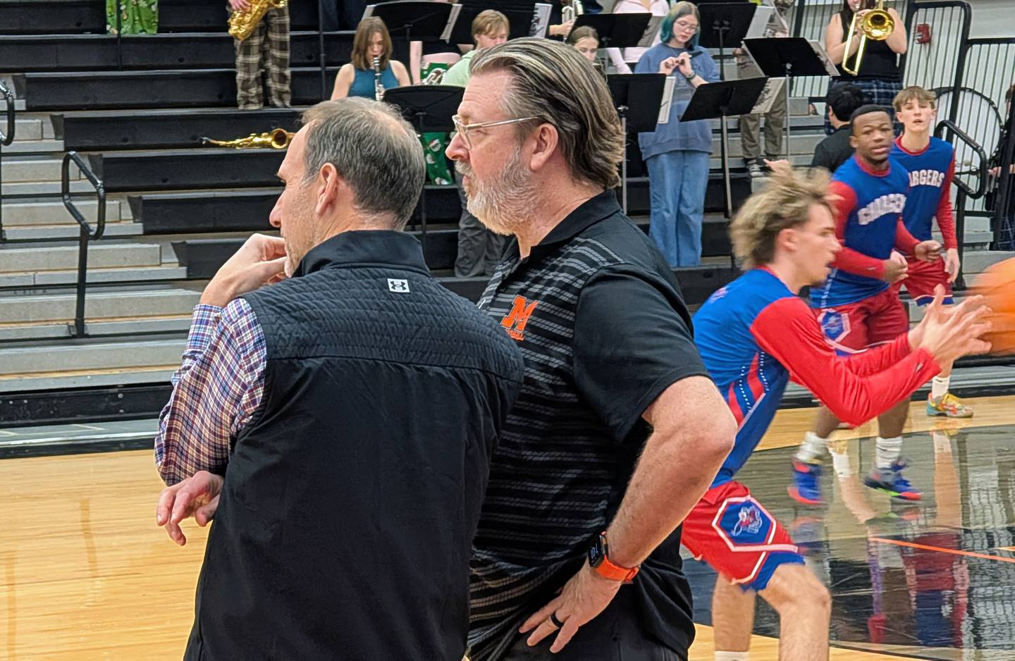 Coaches Lance Huber (left) of Dundee-Crown and Corky Card of McHenry talk before their teams' Fox Valley Conference game Tuesday, Jan. 20, 2025, at McHenry.