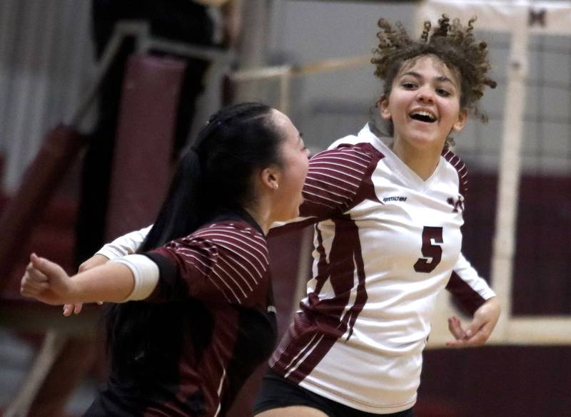 Marengo’s Marlee Gordon, right, and Abigail Paiz celebrate a second-set win over Marian Central in IHSA Class 2A  Regional volleyball action on Monday, Oct. 28, 2024, at  Marengo High School  in Marengo.