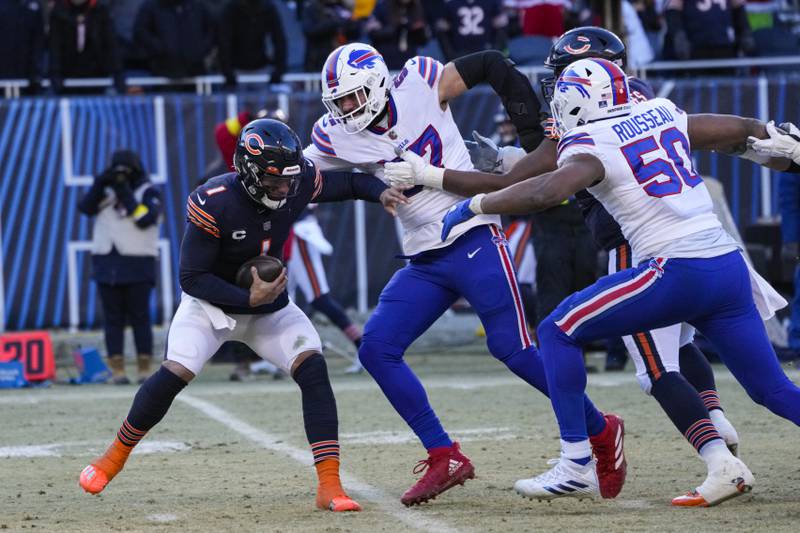 Chicago Bears quarterback Justin Fields is sacked by Buffalo Bills defensive end A.J. Epenesa in the second half, Saturday, Dec. 24, 2022, in Chicago.