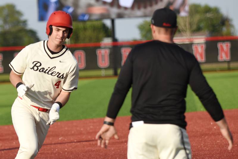 Bradley-Bourbonnais' Eric Rainbolt, left, approaches coach Brad Schweigert during his home run trot in a home game against Stagg Friday, May 8, 2026.