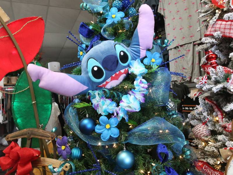 A "Lilo and Stitch" Hawaiian themed Christmas tree is on display on Tuesday, Nov. 12, 2024 at Upscale Resale in Spring Valley.  For over 17 years the business has hosted a yearly Christmas Tree and Decor Auction, featuring unique items and themed trees that customers can add to their collections. The items will be on display in the window of the business, located at 214 W. St. Paul St. in Spring Valley. The auction takes place Thursday from 10a.m.-2p.m. Proceeds from the auction will go toward Upscale’s Helping Hands Charity to help out local communities.