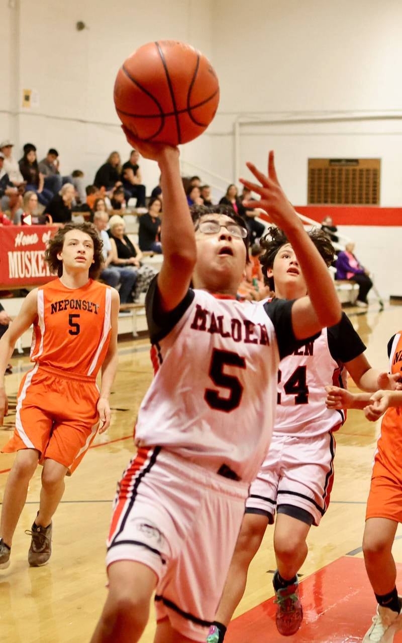 Malden's Joel Salazar shoots a layup against Neponset in Wednesday's game at the Malden Tournament. The Musketeers won 31-13.