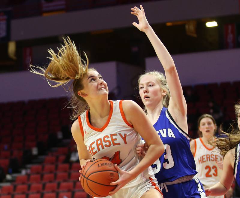 Hersey's Annika Manthy runs in the lane to look at the basket as Geneva's Lauren Slagle defends during the Class 4A third place game on Friday, March 3, 2023 at CEFCU Arena in Normal.