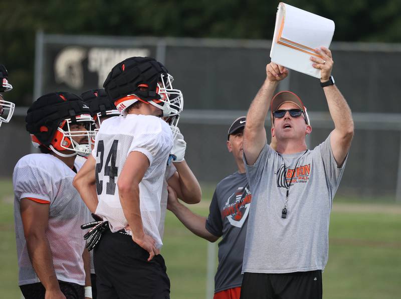 Byron head football coach Jeff Boyer calls a play for his team Thursday, July 24, 2025, during a joint practice with Byron, Lena-Winslow and Sycamore at Sycamore High School.