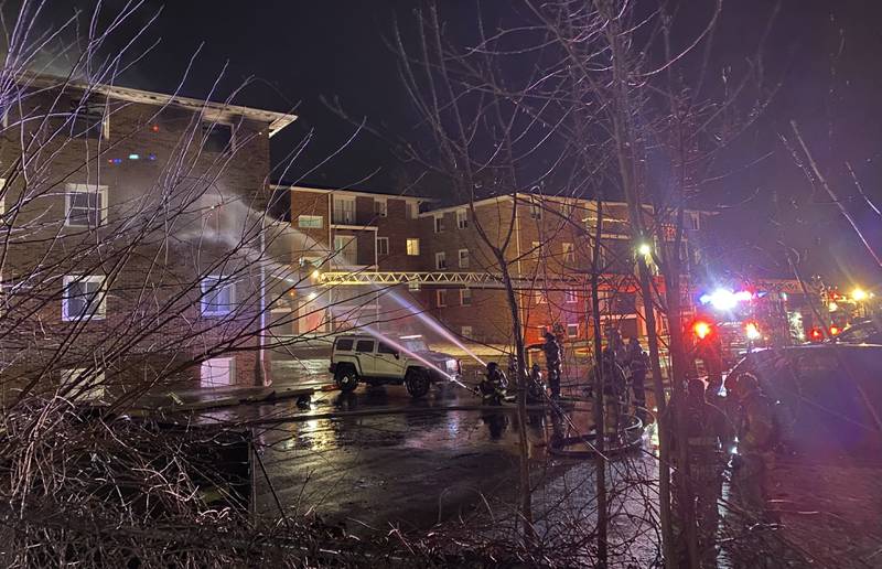 Firefighters from multiple agencies deploy hoses from the parking lot on Sunday, Dec. 22, 2024, at 1024 W. Hillcrest Drive, where a fire broke out inside an apartment complex. Multiple residents were impacted, authorities said.