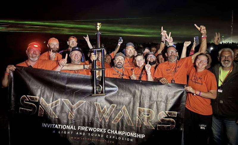 John Mikrut of Princeton, center holding the trophy, is pictured with his team after winning the Pro Division of the Star Wars premier national fireworks competition in Innsbruck, Mo.