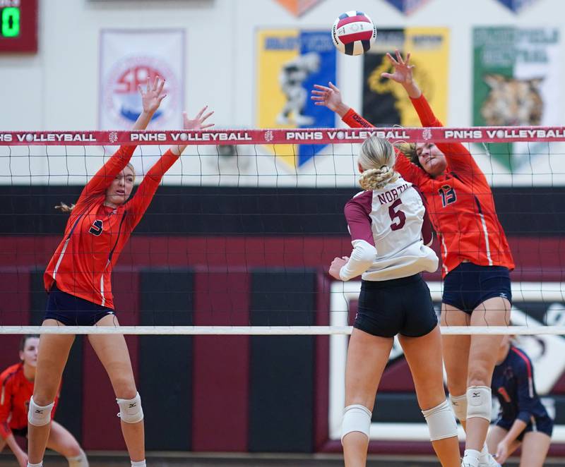 Oswego’s Riley Borrowman (3) and Sidney Hamaker (13) defend the net against a kill attempt by Plainfield North's Elizabeth Fitzgerald (5) during the class 4A Plainfield North regional volleyball final at Plainfield North High School on Thursday, Oct. 26, 2023.