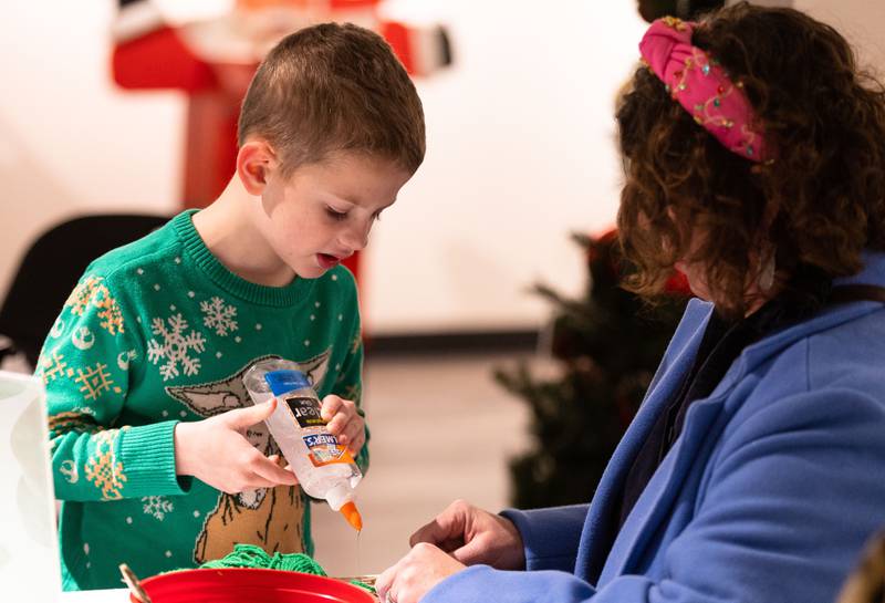 Brennan Binenfeld, 8, makes a Christmas tree ornament with his mom Shannon Binenfeld during a Merry & Bright Victorian Christmas at the Downers Grove Museum on Saturday, Dec. 14, 2024.