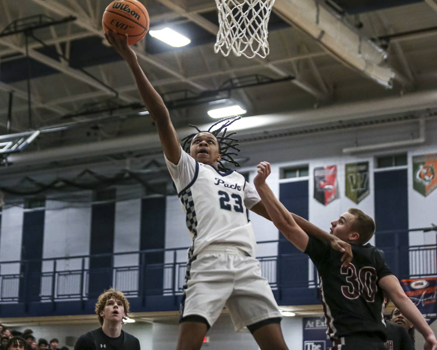 Oswego East's Mason Lockett IV (23) puts in a layup during their basketball game between Plainfield North at Oswego East Friday, Dec 5, 2025 in Oswego.