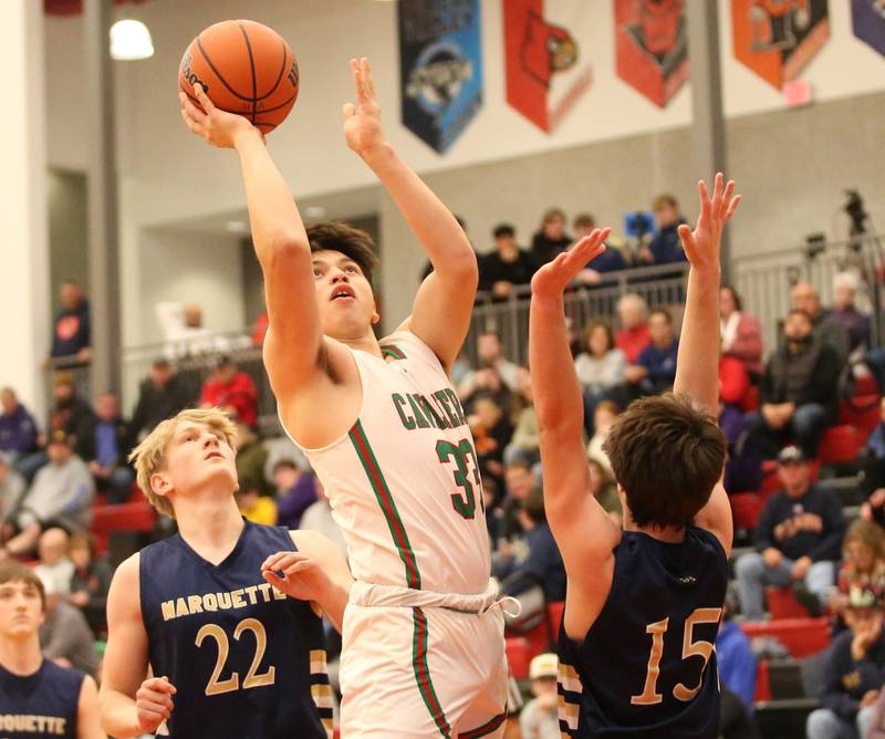 L-P's Eric Sotelo runs in the lane to shoot a jump shot over Marquette's Alec Novotney during the 49th annual Colmone Classic Tournament on Wednesday, Dec. 6, 2023 at Hall High School.