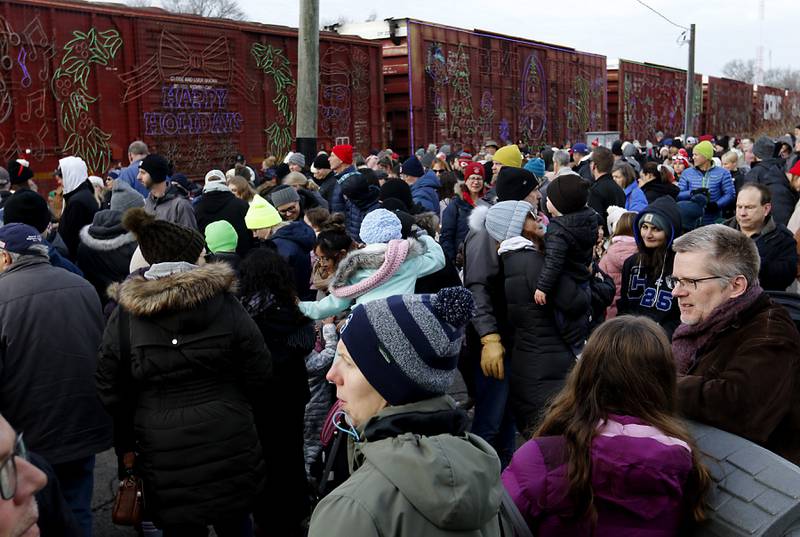 People watch the Canadian Pacific Kansas City Railway 2024 Holiday Train on Wednesday Nov. 27, 2024,  as the train pulls into Pingree Grove. The holiday train raised food and monetary donations for the D300 Food Pantry during its stop in Pingree Grove.
