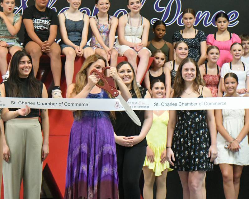 Beth Fowler cuts the ribbon during the 40 year anniversary open house of the Beth Folwer School of Dance held on Saturday June 15, 2024 in St. Charles.