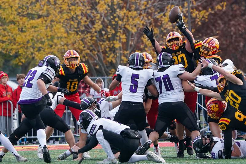 Batavia’s Gavin Pecor (90) deflects a field goal attempt by Downers Grove North's Antonio Kollintzas (22) during a class 7A quarterfinal playoff football game at Batavia High School on Saturday, Nov. 16, 2024.