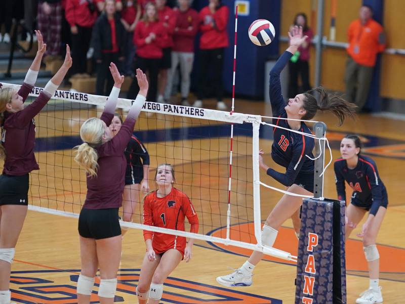 Oswego’s Sidney Hamaker (13) goes up for a kill against Lockport during a class 4A Oswego Sectional semifinal match at Oswego High School on Monday, Oct. 30, 2023.