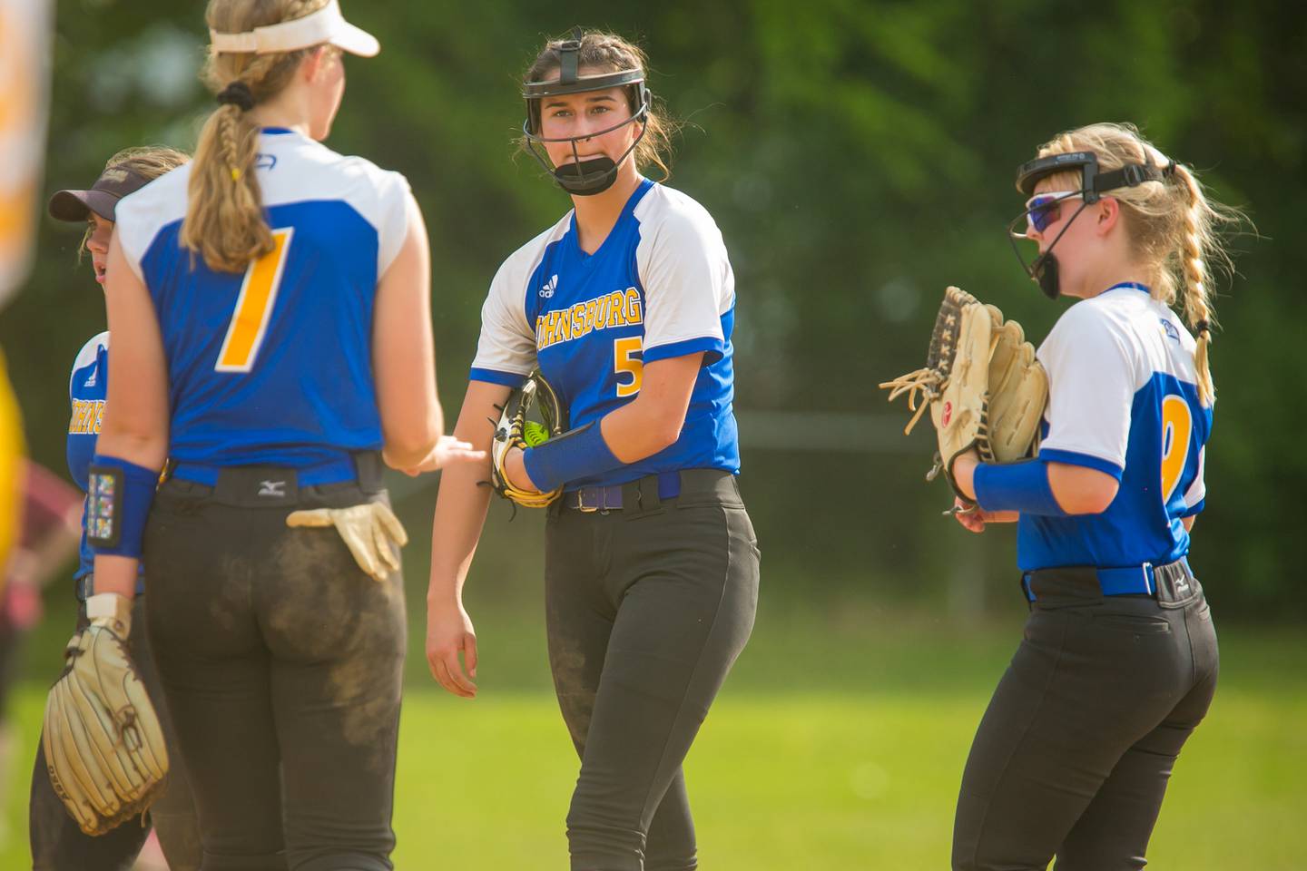 Johnsburg pitcher Addison Mass (5) looks toward Avery Maleug (7) as they huddle for a talk in the third inning of the game at Richmond-Burton High School on Monday, May 24, 2021, in Richmond, Ill. The Skyhawks won, 7-1, and stay undefeated in KRC at 7-0.