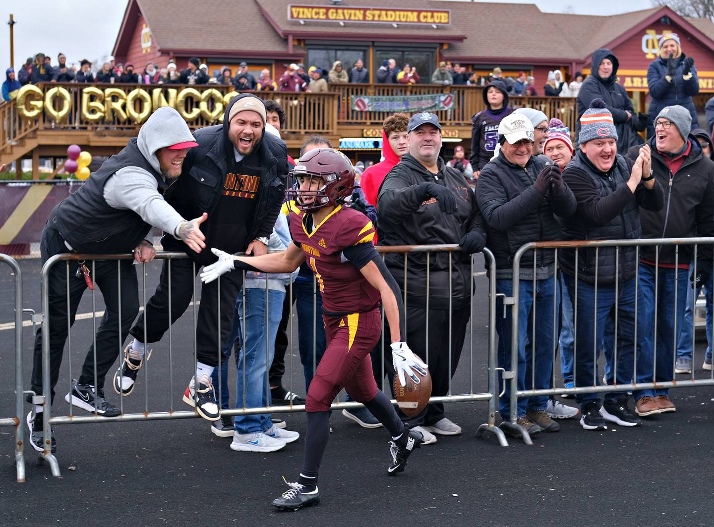Montini's Santino Florio completes sharing high fives with a row of fans after scoring a touchdown during a Class 3A semifinal game on November 23, 2024 at Montini Catholic High School in Lombard.