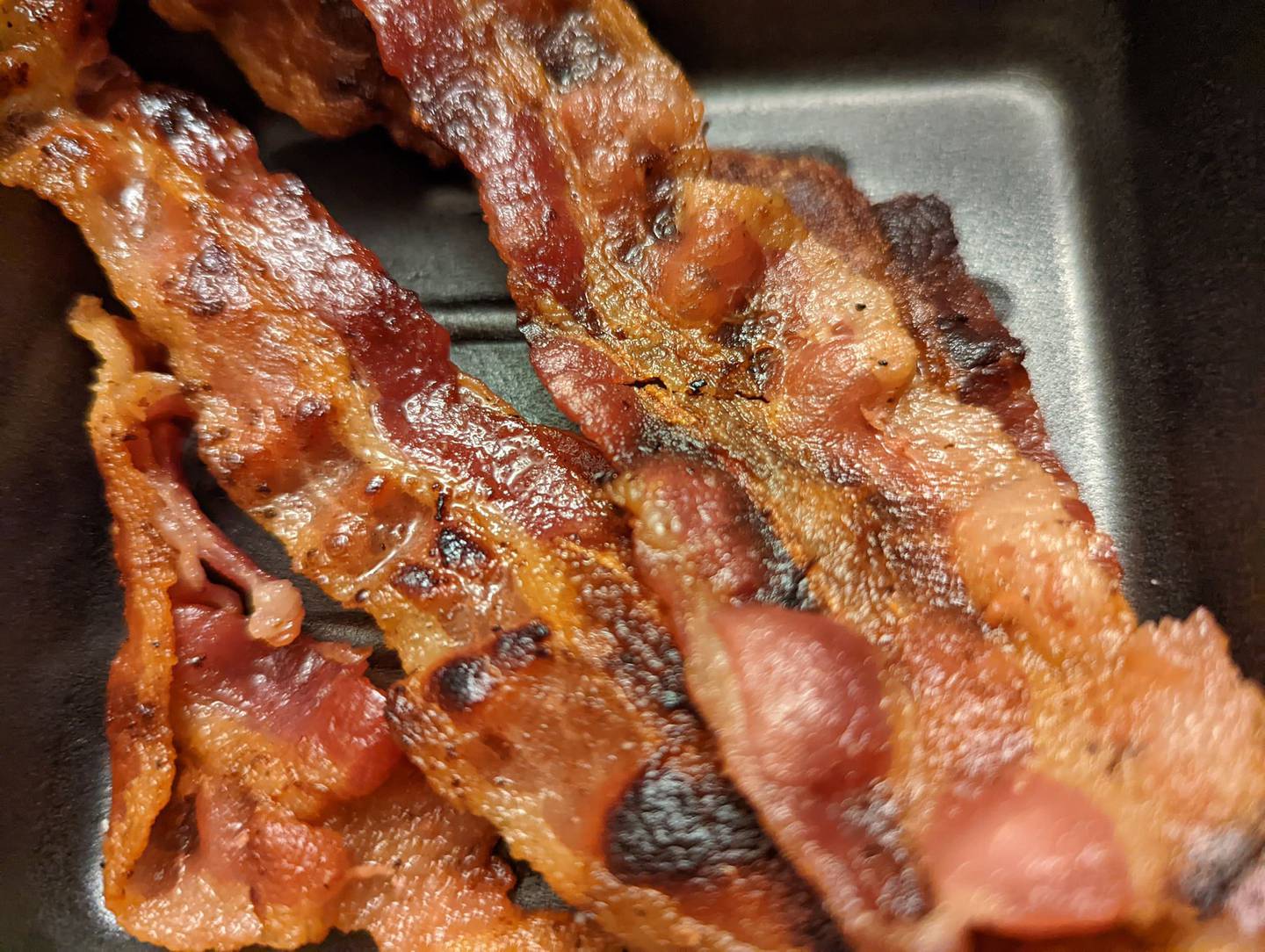Pictured is a side of four strips of bacon for $4.24 from Happy Place Cafe in Shorewood.