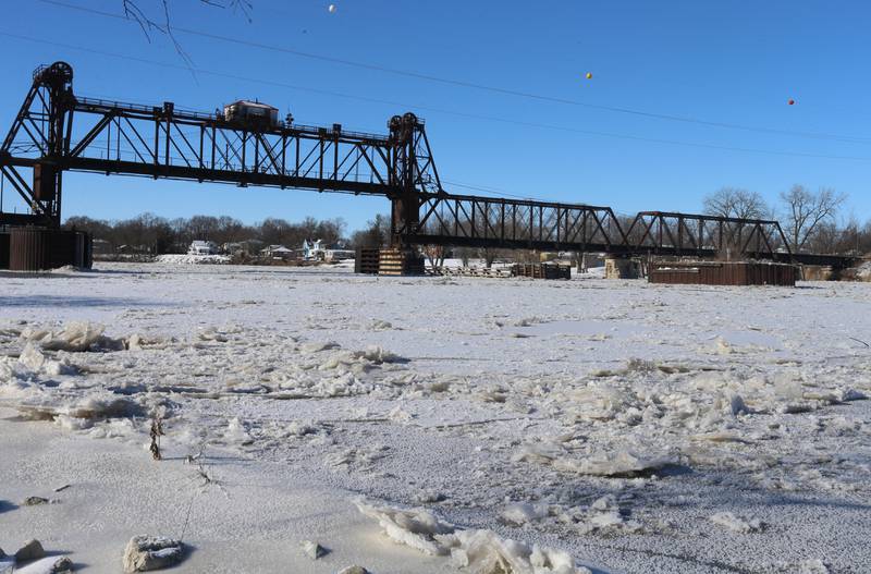 The Illinois River remains frozen underneath the Railroad Bridge  on Tuesday, Jan. 16, 2024, in Ottawa.