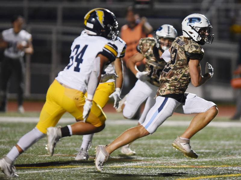 Joe Lewnard/jlewnard@dailyherald.com
Prospdct's Nicholas Carlucci carries the ball for a touchdown against Glenbrook South during Thursday’s game in Mount Prospect.