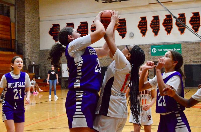 Rochelle's Sophia Reynolds (left) fights for a rebound with DeKalb's Jada Gavin during a seventh grade girls basketball game.