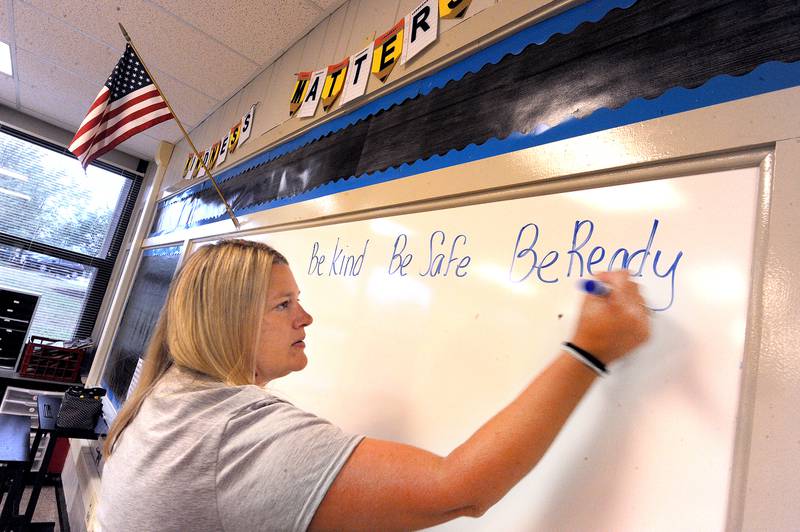 Second-grade teacher Melissa Condon writes a message on the white board to prepare for the first day of classes at Yorkville Grade School on Friday, Aug. 15, 2024.