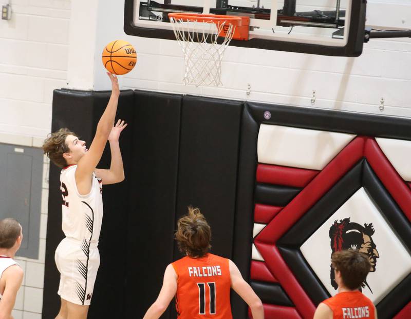 Woodland's Zandar Radke lets go of the ball under the hoop as Flanagan-Cornell's Logan Ruddy arrives late to the play during the Route 17 Classic Tournament on Wednesday, Nov. 27, 2024 at Woodland High School.