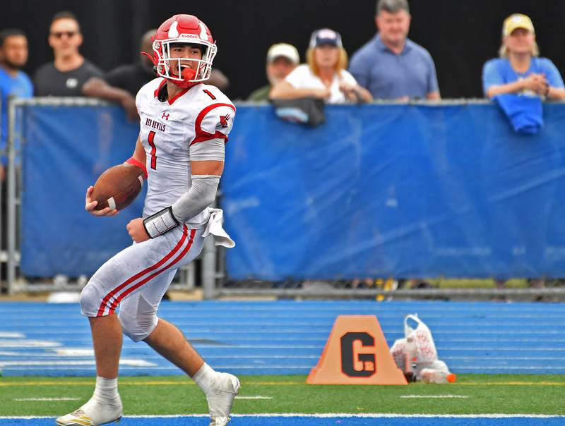 Hinsdale Central quarterback Riley Contreras scores a late touchdown to all but seal the win over Lyons Township during a game on September 20, 2025 at Lyons Township High School in LaGrange.