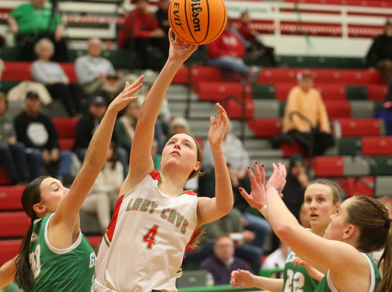 L-P's Alexus Hines lets go of a shot under the hoop between Geneseo defeners Kendyl Wassenhove and teammate Payton Snider on Tuesday, Feb. 4, 2025 in AJ Sellett Gymnasium at L-P High School.