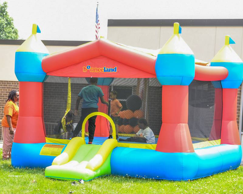 Kids enjoy the bouncy house on Saturday, June 7, 2025, during the Ezra Hill Jr. Memorial Foundation’s 5th annual rock painting event held at Tyler Elementary School in DeKalb. The foundation was created to memorialize the late DeKalb boy, shot and killed in 2019.