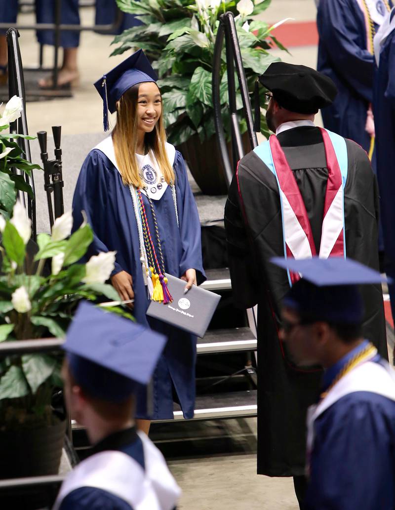 An Oswego East senior receives her diploma on May 21, 2022 in DeKalb.