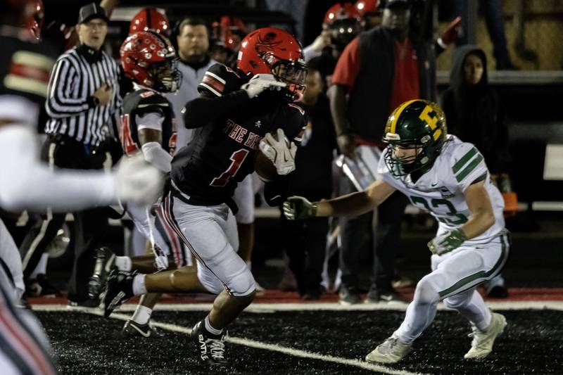 Bolingbrook's Jordan Lampkins picks-up yardage after making an interception during an 8A varsity football playoff game against Fremd at Bolingbrook on Nov. 15, 2025.