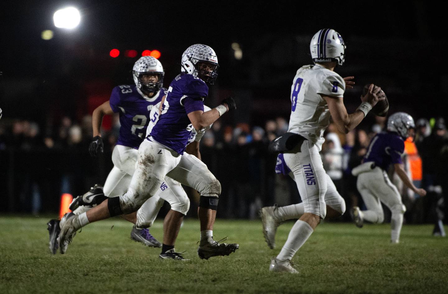 Wilmington's Logan Van Duyne, center, chases after El Paso-Gridley's Owen Admas, right, in the Class 2A semifinal on Saturday, November 22, 2025.
