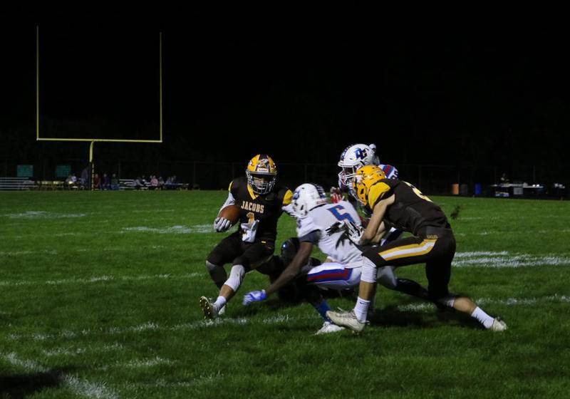 Jacobs wide receiver Joshua Hill tries to avoid a tackle Friday evening during the Golden Eagles' 41-7 over Dundee-Crown in Algonquin. Jacobs improved to 2-1 with the win.
