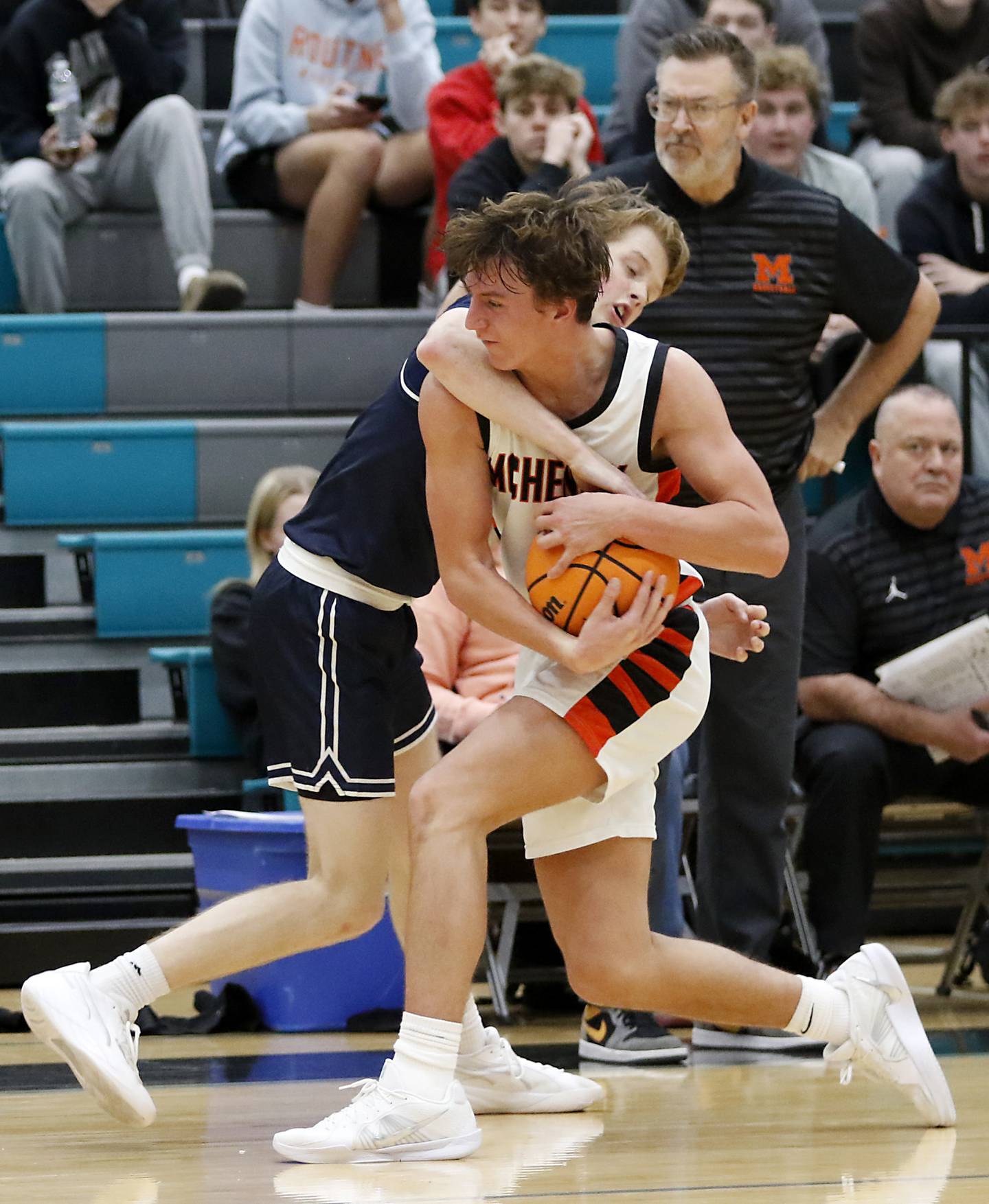 Cary-Grove's AJ Berndt fouls McHenry's Dylan Hurckes in overtime during the Woodstock Hoops for Healing Tournament Championship game on Wednesday, Nov. 27, 2024, at Woodstock North High School.