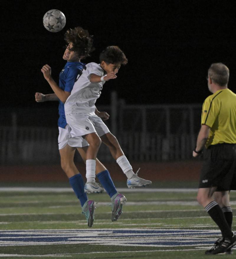 St. Charles North’s Jack Suliman and West Chicago’s Julian Lopez, right, compete for the ball in a boys soccer game in St. Charles on Wednesday, Sept. 4, 2024.