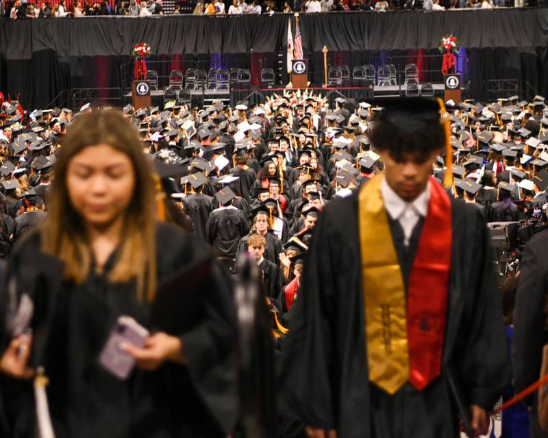 Northern Illinois University graduates file out of the Convocation Center in DeKalb to meet up with friends and family on Saturday May 9, 2026, after the graduation ceremony was completed.