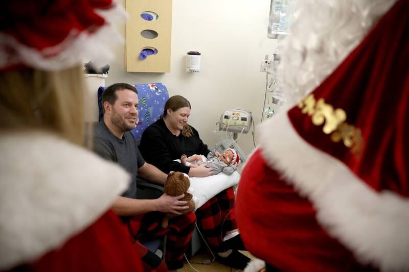 Paul and Amy Latsch of Yorkville and their newborn son, Trevor, get a visit from Santa and Mrs. Claus in the NICU at Northwestern Medicine Central DuPage Hospital in Winfield on Wednesday, Dec. 20, 2023.
