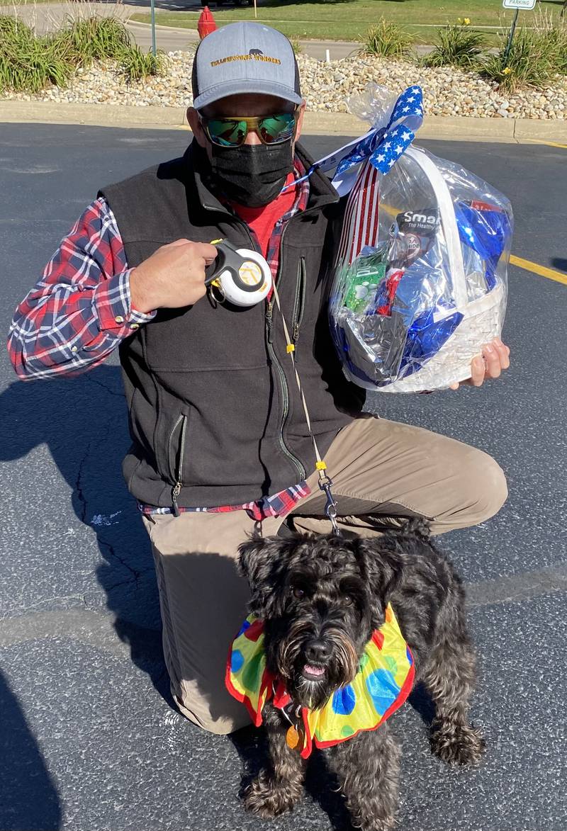 Following the dog parade, a RUFF-le basket filled with various doggie delights was awarded to Goose, a miniature schnauzer.